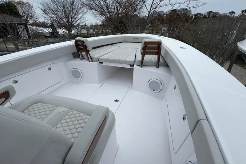  Yacht Photos Pics 2024 Jupiter 32 FS boat interior with cushioned seating and sleek design.