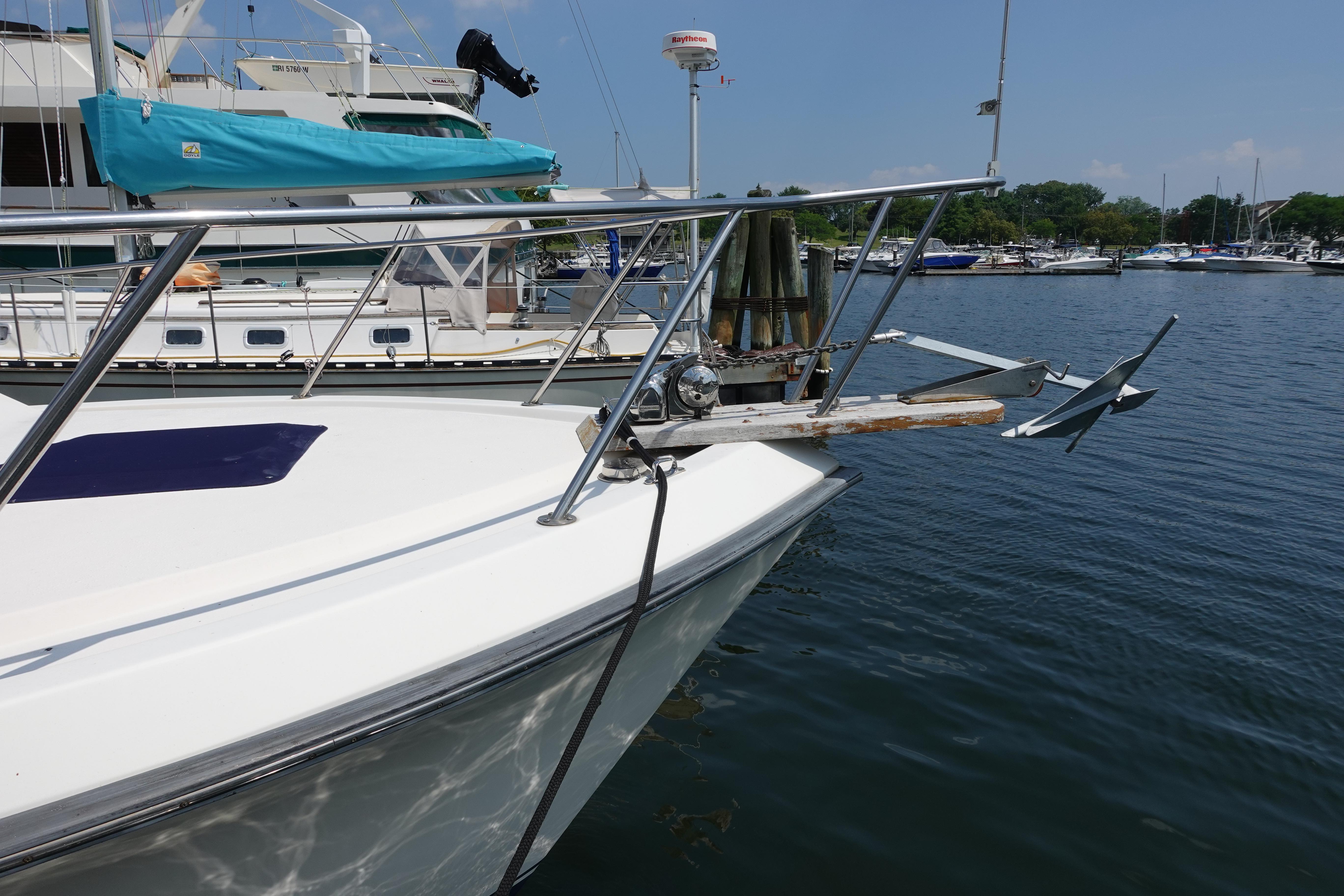1988 Pacemaker 308 boat docked at marina with visible anchor and railing.