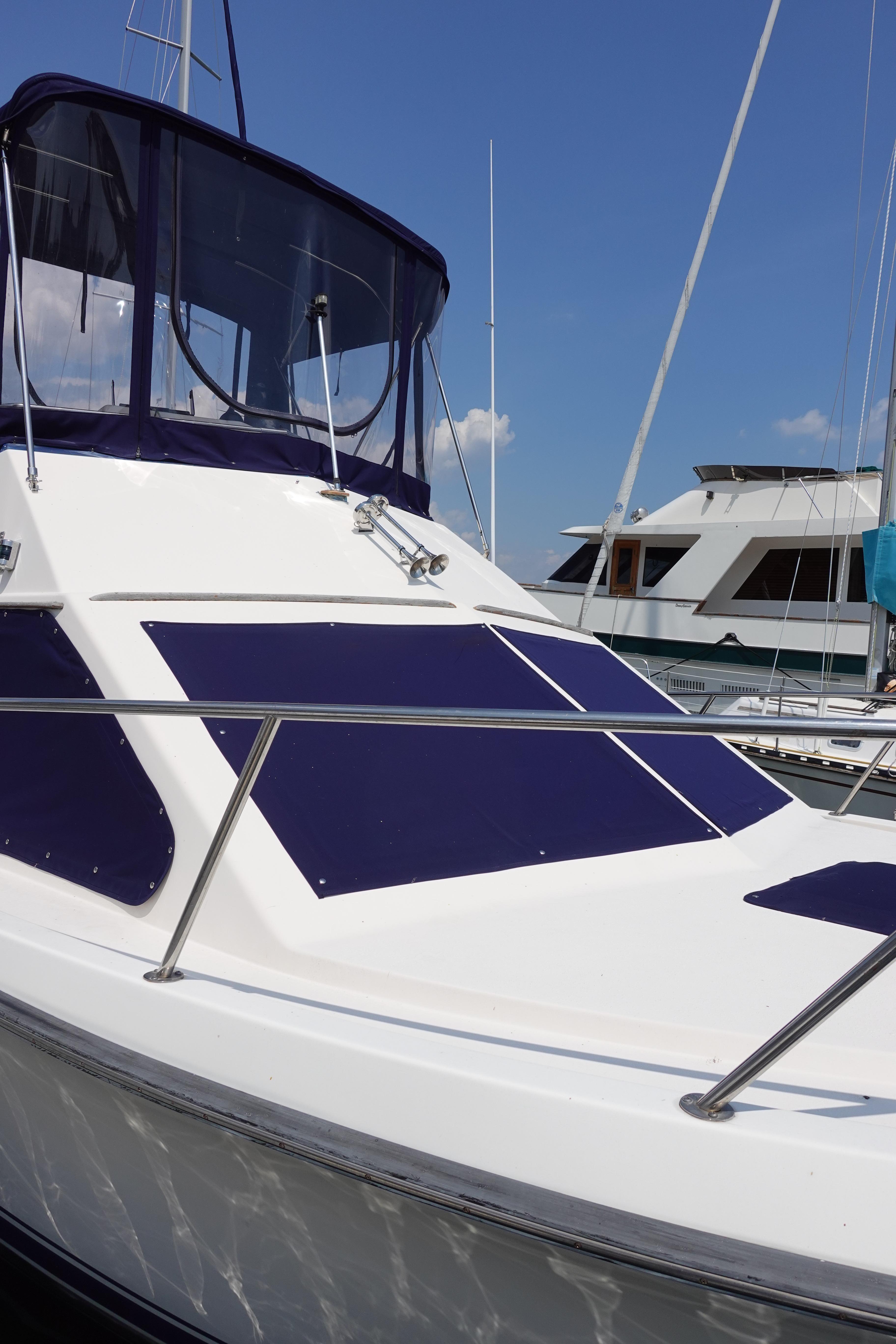 1988 Pacemaker 308 boat docked at marina under clear blue sky.