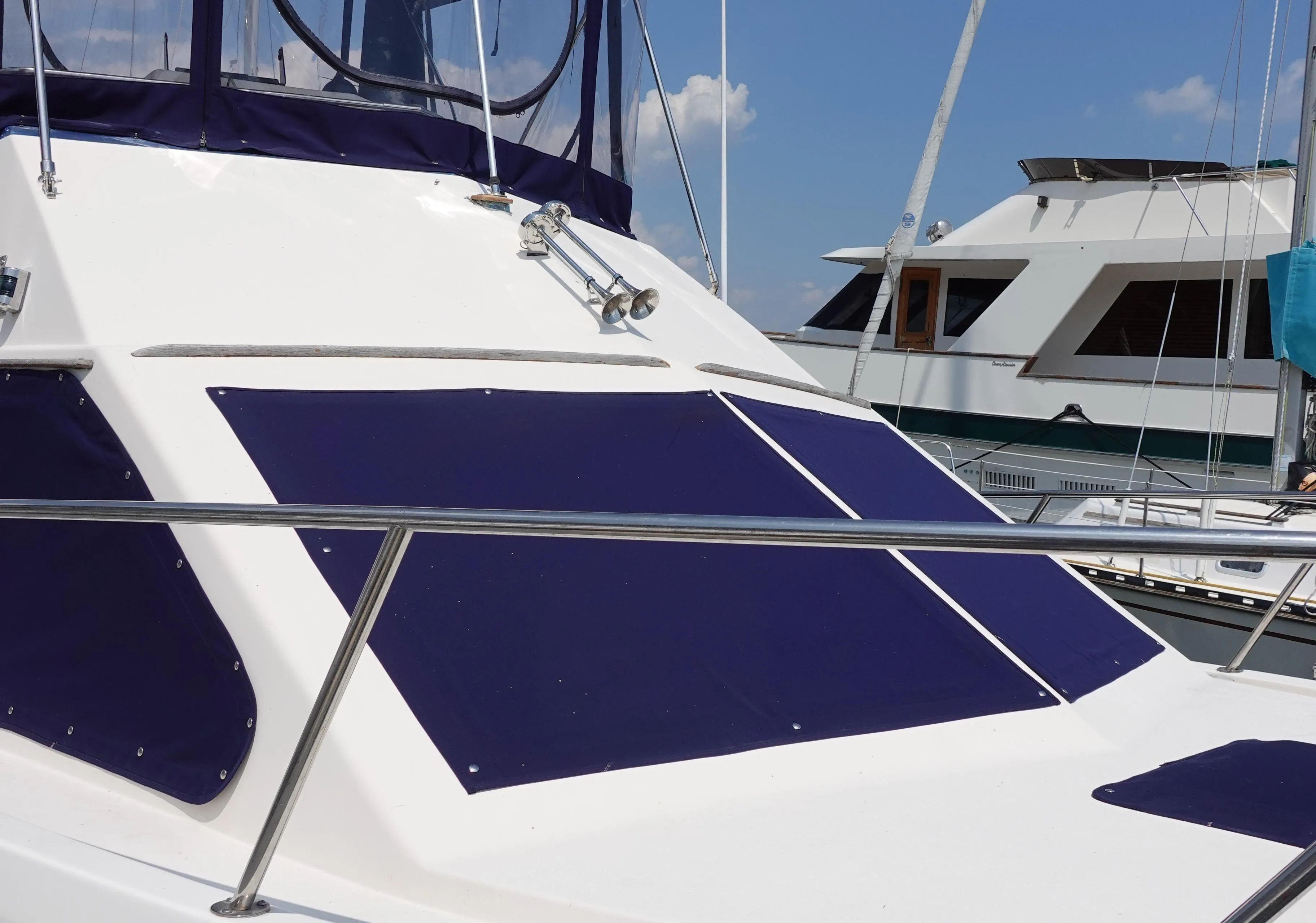 1988 Pacemaker 308 boat docked at marina under clear blue sky.
