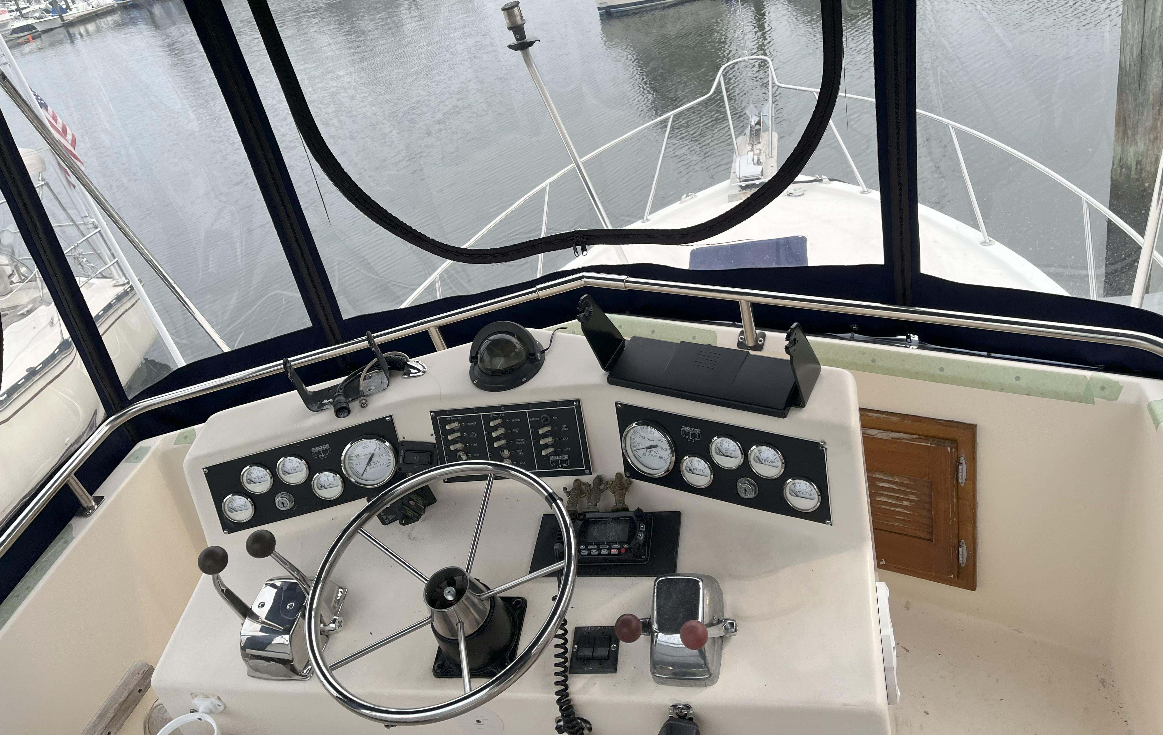 Helm of 1988 Pacemaker 308 boat with steering wheel and control panel.