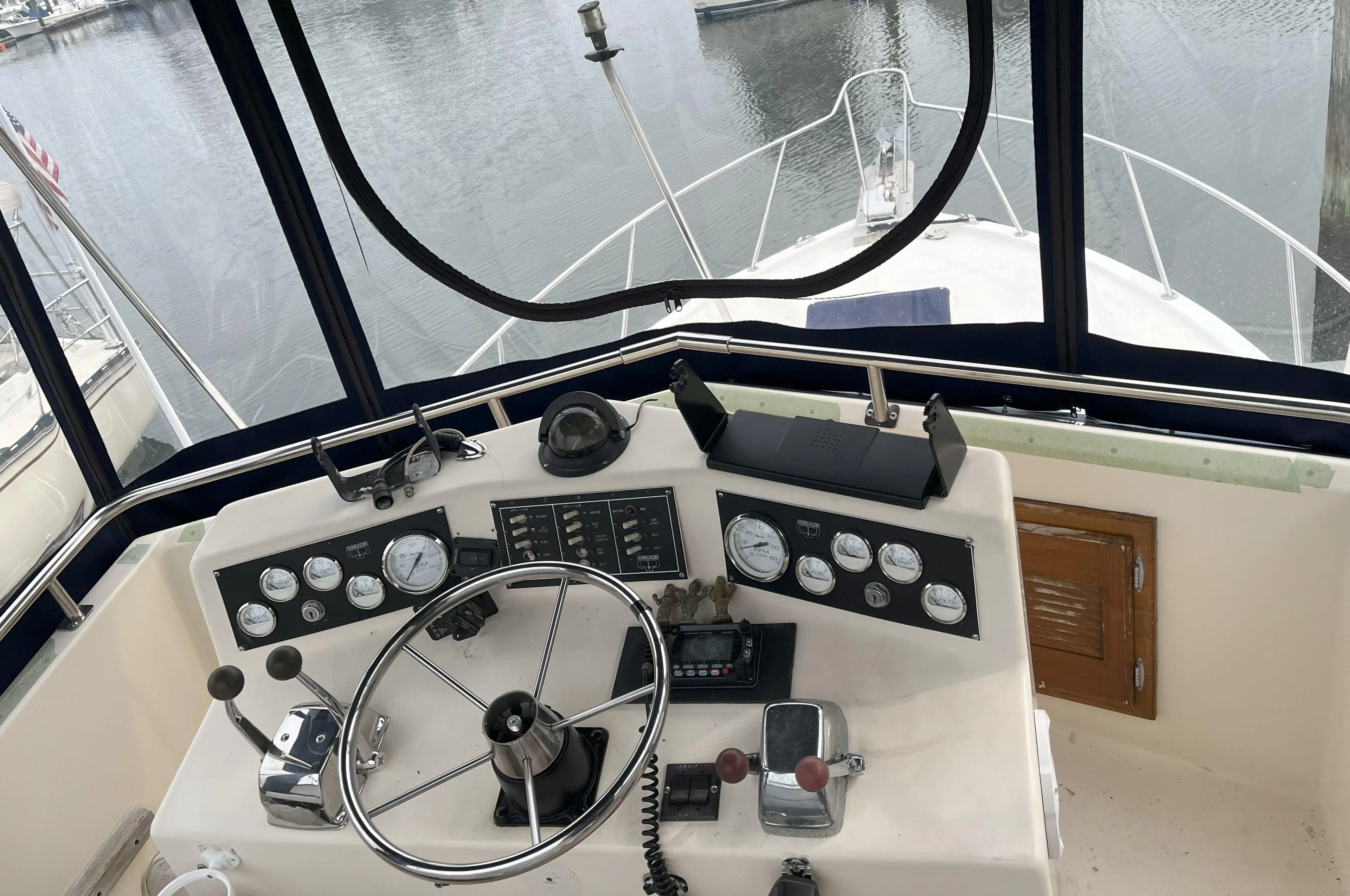 Helm of 1988 Pacemaker 308 boat with steering wheel and control panel.