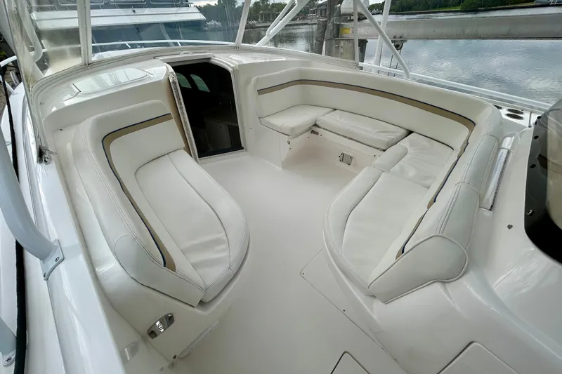  Yacht Photos Pics 2012 Intrepid 400 Cuddy boat interior with white cushioned seating and open cabin.