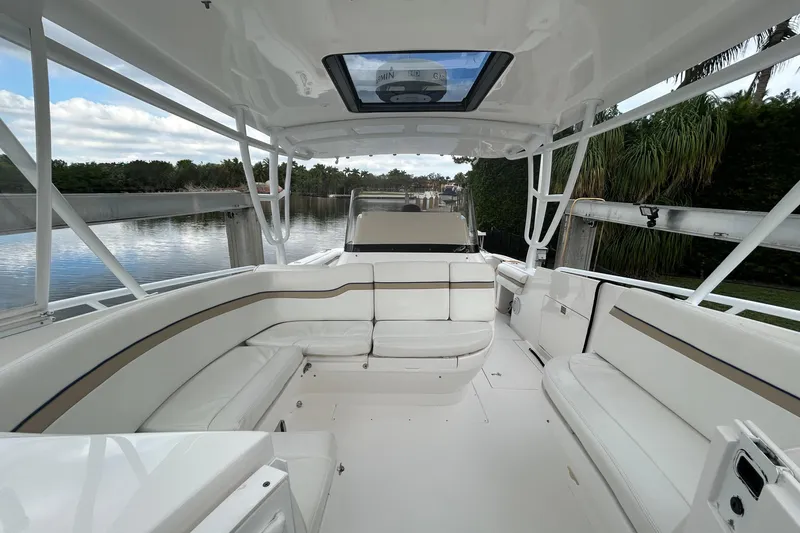  Yacht Photos Pics 2012 Intrepid 400 Cuddy boat interior with white seating and open canopy.