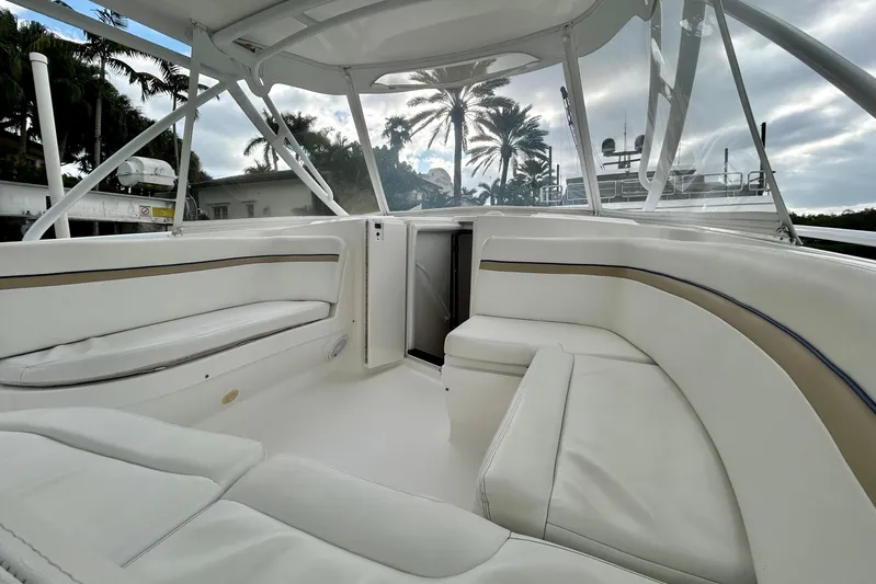  Yacht Photos Pics Luxurious interior of 2012 Intrepid 400 Cuddy boat with white seating and palm trees.