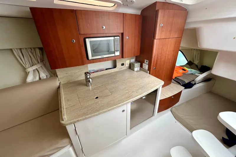  Yacht Photos Pics 2012 Intrepid 400 Cuddy interior with kitchenette, microwave, and seating area.