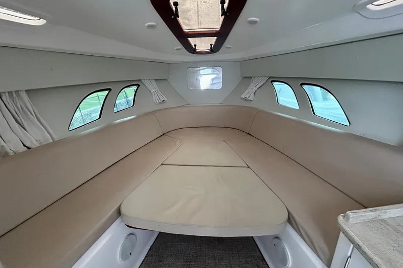  Yacht Photos Pics Interior of 2012 Intrepid 400 Cuddy boat with beige seating and windows.