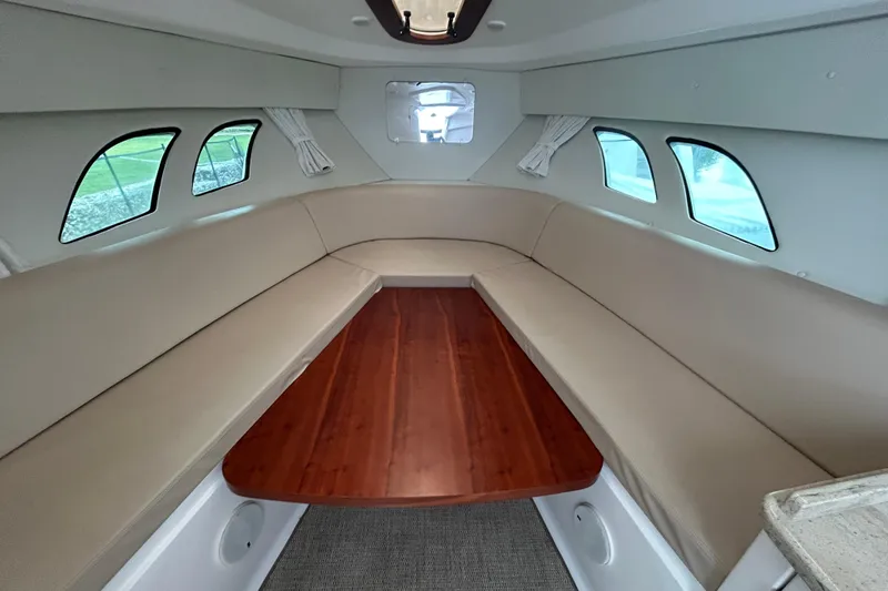  Yacht Photos Pics 2012 Intrepid 400 Cuddy interior with beige seating and wooden table.