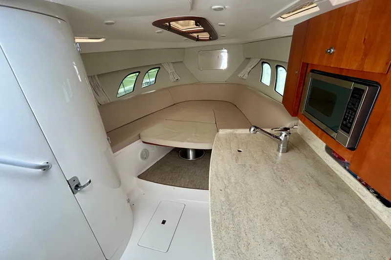  Yacht Photos Pics Interior of 2012 Intrepid 400 Cuddy, featuring kitchenette and seating area.