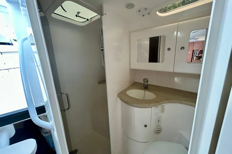  Yacht Photos Pics 2012 Intrepid 400 Cuddy bathroom with sink, mirror, and storage cabinets.