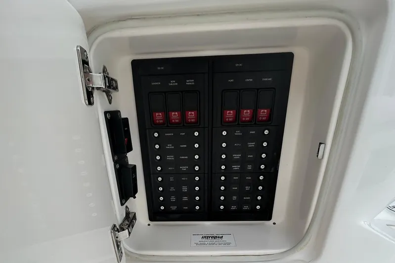  Yacht Photos Pics Electrical panel of a 2012 Intrepid 400 Cuddy boat, featuring labeled switches and controls.