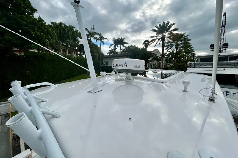  Yacht Photos Pics 2012 Intrepid 400 Cuddy boat deck with Garmin radar, surrounded by palm trees.
