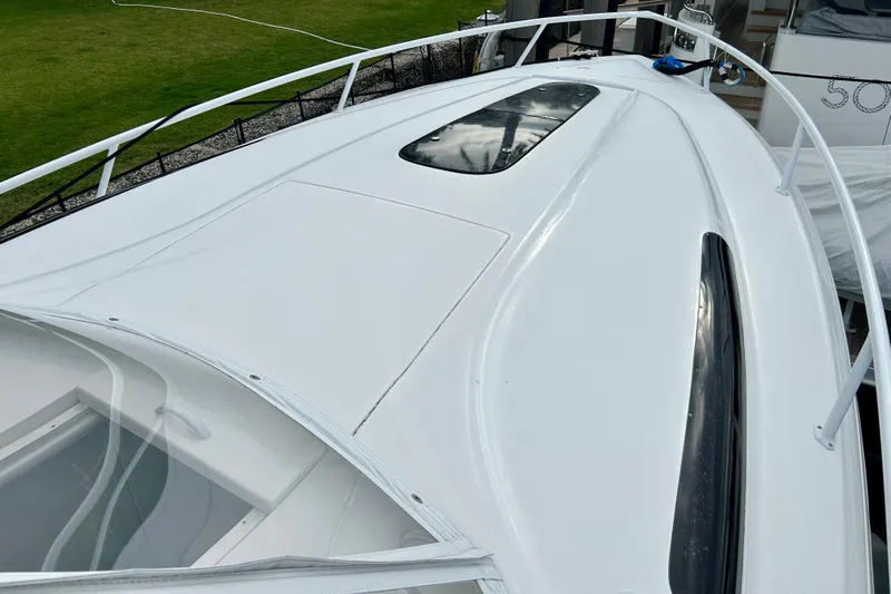  Yacht Photos Pics 2012 Intrepid 400 Cuddy boat deck with sleek white design and railing.