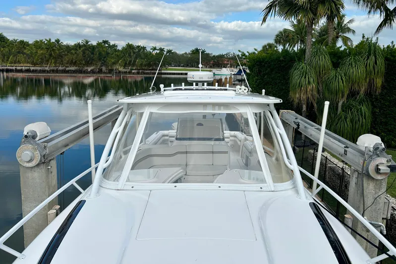  Yacht Photos Pics 2012 Intrepid 400 Cuddy boat docked by tropical waterfront.