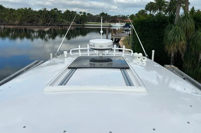  Yacht Photos Pics 2012 Intrepid 400 Cuddy boat with Garmin radar, docked by a scenic waterfront.