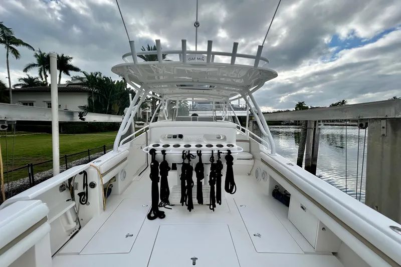 Yacht Photos Pics 2012 Intrepid 400 Cuddy boat deck with fishing rod holders, docked by a waterfront.