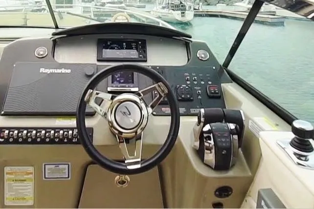 Money Making Mitch Yacht Photos Pics Cockpit of 2015 Sea Ray 370 Venture boat with steering wheel and control panel.