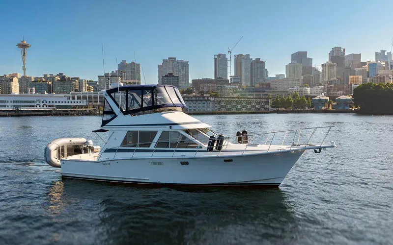 La Paz Yacht Photos Pics 1993 Tollycraft 40 Sport Sedan yacht on water with city skyline in background.