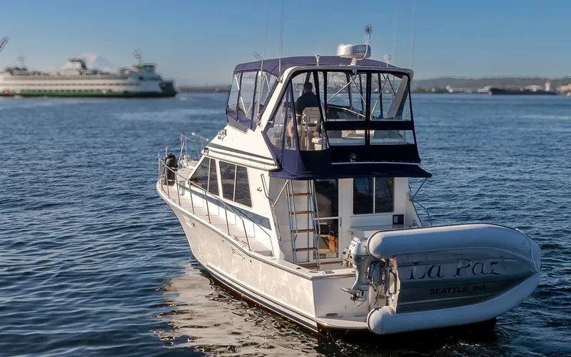 La Paz Yacht Photos Pics 1993 Tollycraft 40 Sport Sedan yacht on calm water with ferry in background.