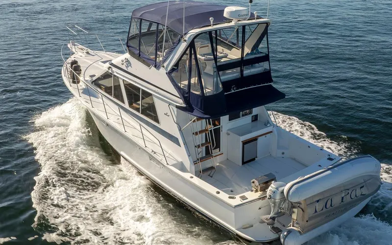 La Paz Yacht Photos Pics 1993 Tollycraft 40 Sport Sedan cruising on open water, rear view.