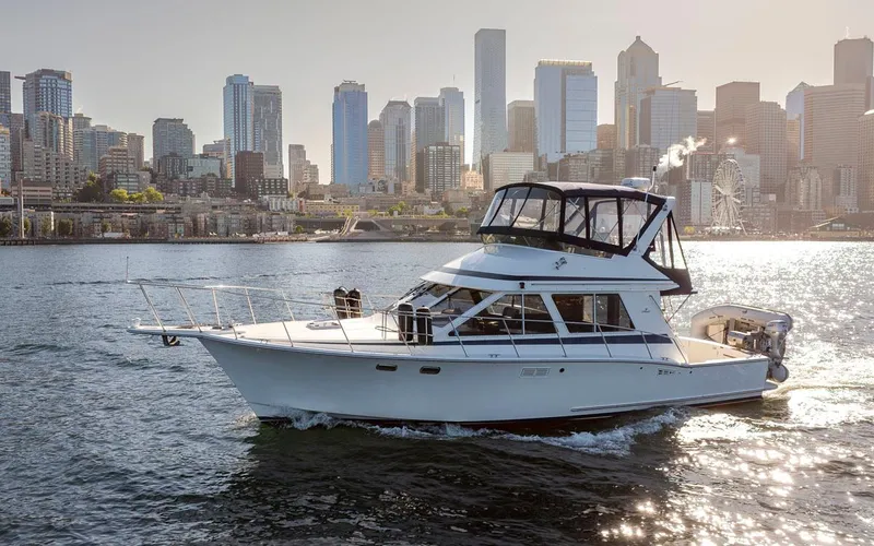 La Paz Yacht Photos Pics 1993 Tollycraft 40 Sport Sedan cruising with city skyline in background.