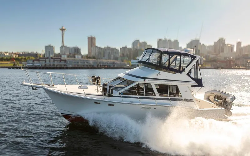 La Paz Yacht Photos Pics 1993 Tollycraft 40 Sport Sedan cruising with city skyline in the background.