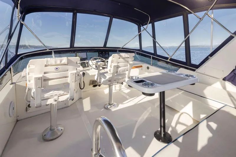 La Paz Yacht Photos Pics 1993 Tollycraft 40 Sport Sedan cockpit with helm, seating, and ocean view.