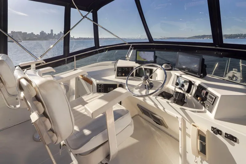 La Paz Yacht Photos Pics 1993 Tollycraft 40 Sport Sedan helm with city skyline view, featuring modern navigation equipment.