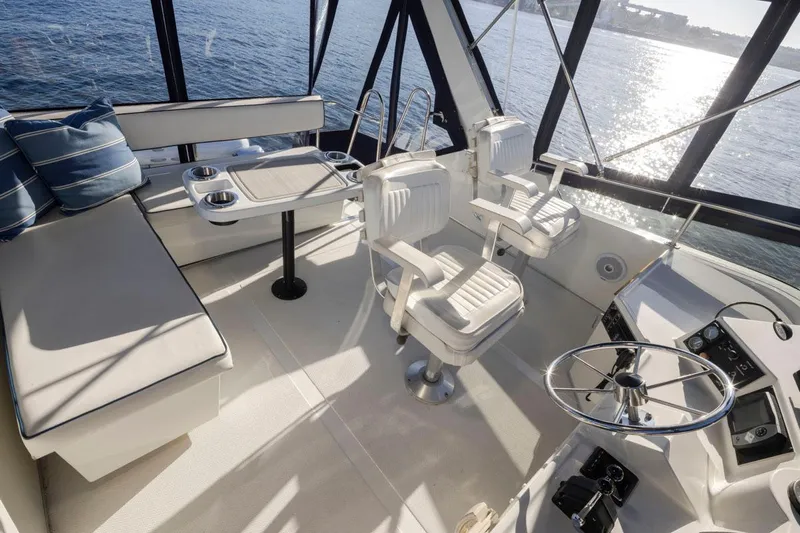 La Paz Yacht Photos Pics 1993 Tollycraft 40 Sport Sedan interior with helm, seating, and ocean view.