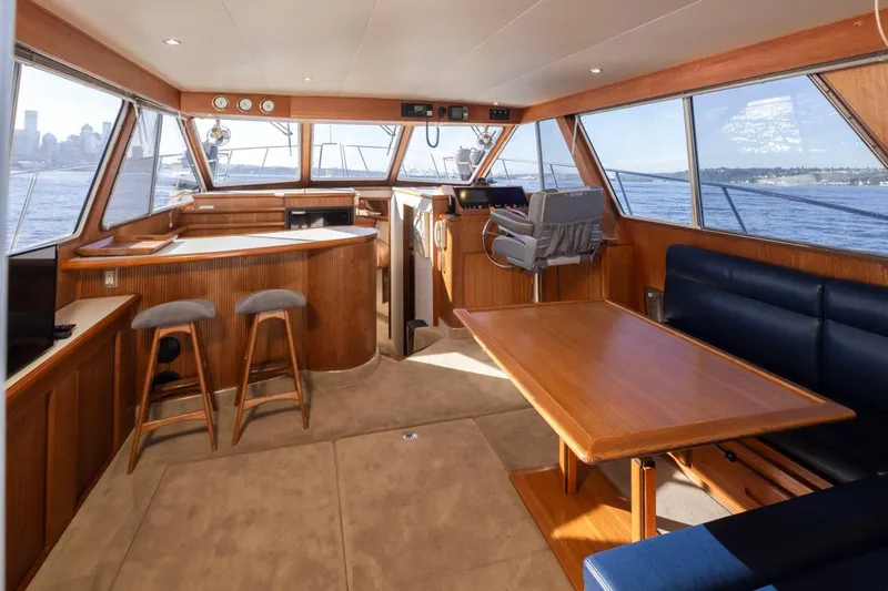 La Paz Yacht Photos Pics 1993 Tollycraft 40 Sport Sedan interior with wood accents, seating, and panoramic windows.