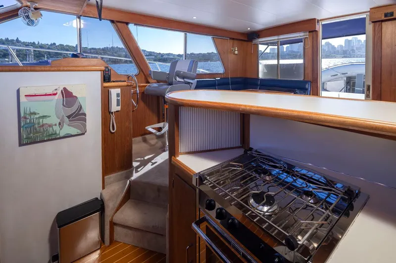 La Paz Yacht Photos Pics Interior of 1993 Tollycraft 40 Sport Sedan with kitchen and seating area.