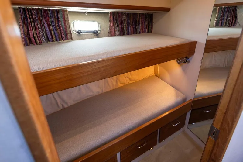 La Paz Yacht Photos Pics 1993 Tollycraft 40 Sport Sedan cabin with wooden bunk beds and storage drawers.