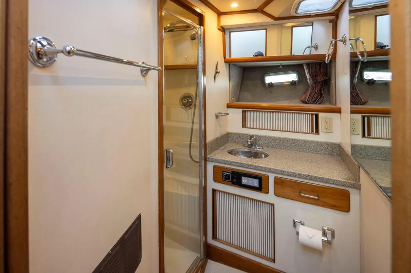 La Paz Yacht Photos Pics 1993 Tollycraft 40 Sport Sedan bathroom with shower, sink, and storage cabinets.