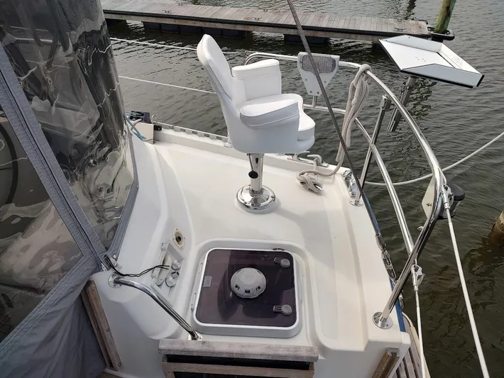 Seeker Yacht Photos Pics 2005 Stevens Custom 53/56 yacht deck with white captain's chair and railing.