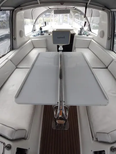 Seeker Yacht Photos Pics Luxurious interior of 2005 Stevens Custom 53/56 yacht with white seating and navigation equipment.