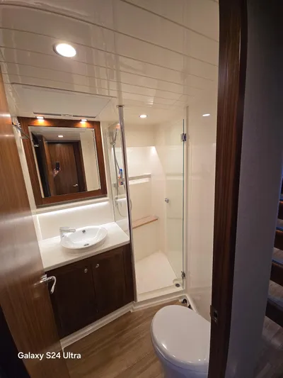 Ocean Driver Yacht Photos Pics Luxurious bathroom in 2022 Riviera 54 Enclosed Flybridge yacht, featuring modern fixtures and elegant design.