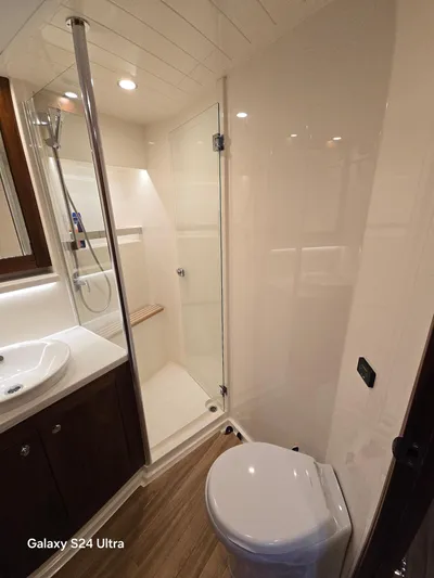 Ocean Driver Yacht Photos Pics Luxurious bathroom in 2022 Riviera 54 Enclosed Flybridge yacht with modern fixtures.