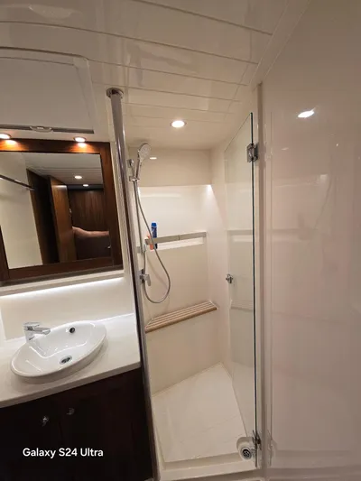 Ocean Driver Yacht Photos Pics Luxurious bathroom in 2022 Riviera 54 Enclosed Flybridge yacht with modern fixtures.