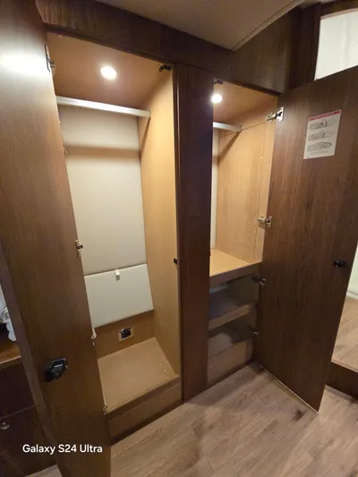 Ocean Driver Yacht Photos Pics Wooden closet interior on a 2022 Riviera 54 Enclosed Flybridge yacht.