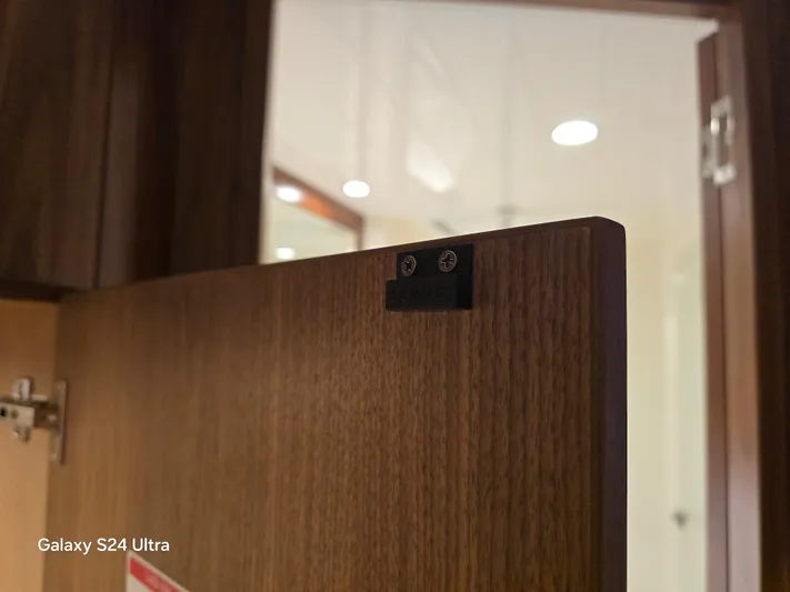 Ocean Driver Yacht Photos Pics Wooden door detail on 2022 Riviera 54 Enclosed Flybridge yacht interior.