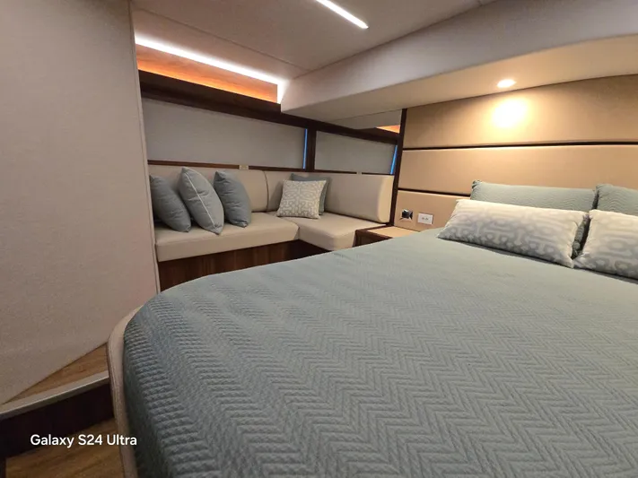 Ocean Driver Yacht Photos Pics Luxurious bedroom interior of 2022 Riviera 54 Enclosed Flybridge yacht with elegant bedding.