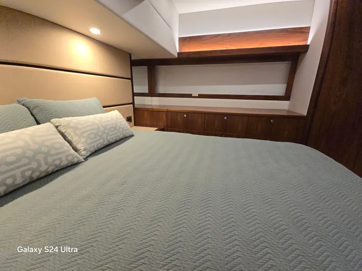 Ocean Driver Yacht Photos Pics Luxurious bedroom interior of 2022 Riviera 54 Enclosed Flybridge yacht.