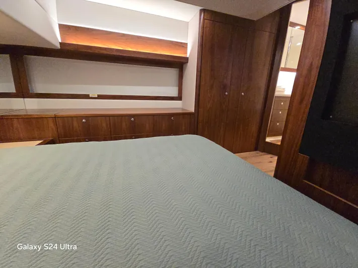 Ocean Driver Yacht Photos Pics Luxurious interior of 2022 Riviera 54 Enclosed Flybridge yacht bedroom.