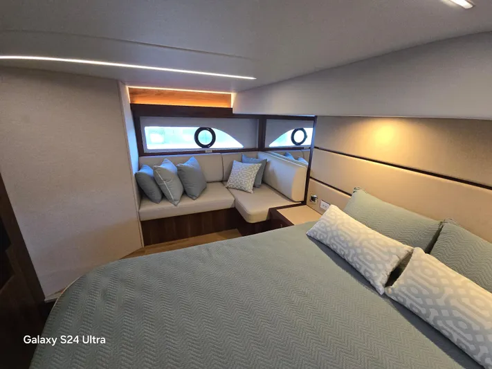 Ocean Driver Yacht Photos Pics Luxurious bedroom interior of 2022 Riviera 54 Enclosed Flybridge yacht with elegant bedding.