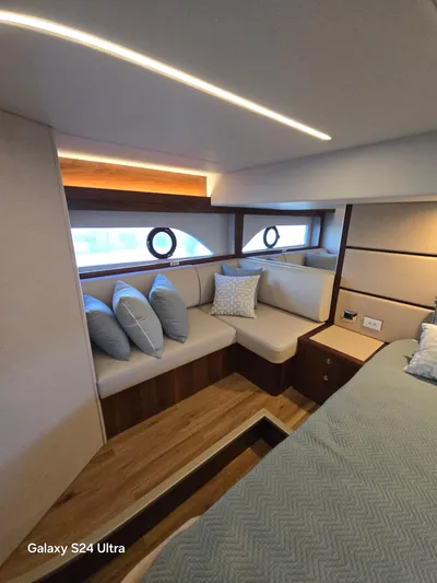 Ocean Driver Yacht Photos Pics Luxurious interior of 2022 Riviera 54 Enclosed Flybridge with elegant seating and modern design.
