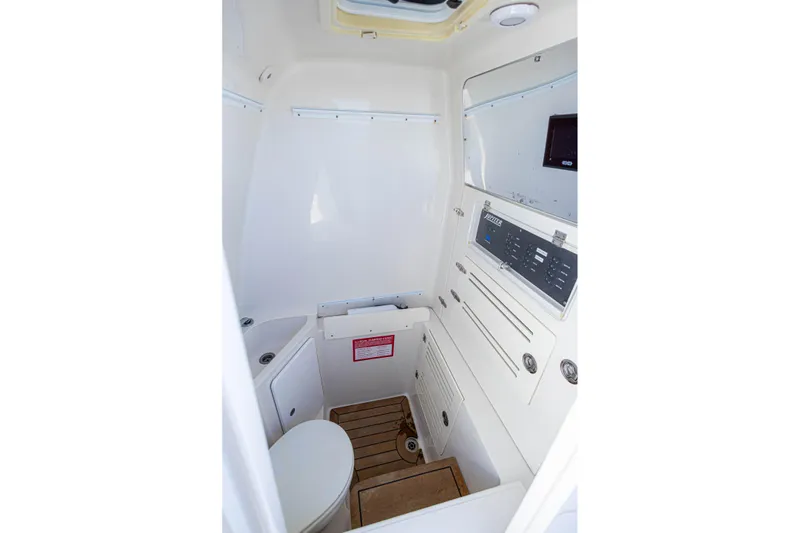 Bandit Yacht Photos Pics Interior of 2018 Jupiter 38 FS boat, featuring a compact marine bathroom with control panel.