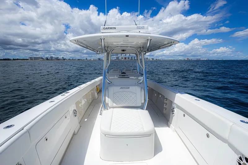 Bandit Yacht Photos Pics 2018 Jupiter 38 FS boat on open water, clear sky, city skyline in background.