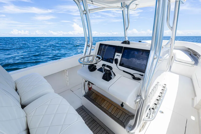 Bandit Yacht Photos Pics 2018 Jupiter 38 FS boat cockpit with modern controls, steering wheel, and ocean view.