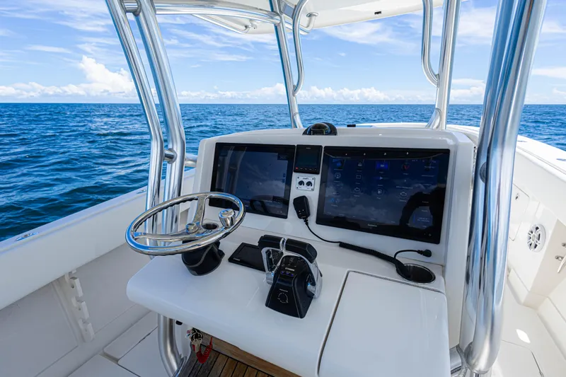 Bandit Yacht Photos Pics 2018 Jupiter 38 FS boat console with dual screens, steering wheel, and ocean view.