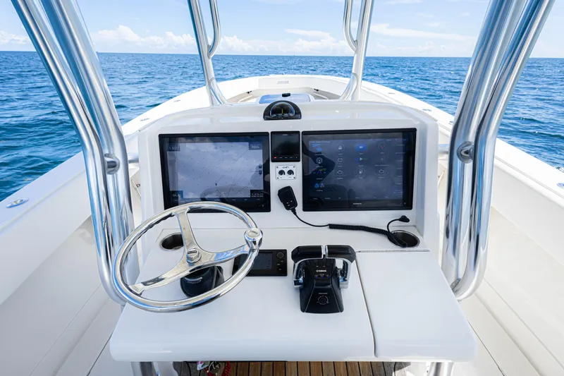 Bandit Yacht Photos Pics 2018 Jupiter 38 FS boat console with dual screens and steering wheel on open sea.